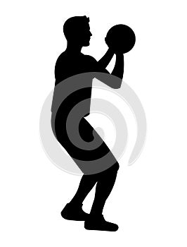 Black silhouette of a basketball player who stands and holds the ball with both hands to make a set shot and shoot ball into the