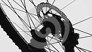 Black silhouette of a bicycle wheel on a white isolated background. Close up of round bike wheel with rubber tread tire