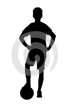 Black silhouette of boy football player who stands upright with his foot on the ball
