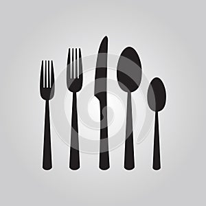 Black silhouette cutlery set including spoon, fork, and knife icons set on gray gradient background