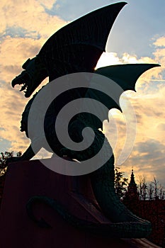 Black silhouette of Dragon from the famous Dragon bridge Zmajski most. Colorful autumn sunset. Travel and tourism concept. photo