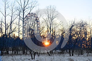 Black silhouette of Ferris wheel , winter park, sunset, evening amusement park