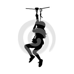 Black silhouette of a girl coming down on zip-line