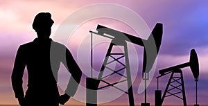 Black silhouette of oil worker and pump jack