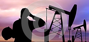 Black silhouette of oil worker and pump jack