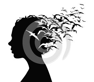 Black silhouette portrait of a pretty girl with birds flying from her head - thoughts, emotions or psychology concept