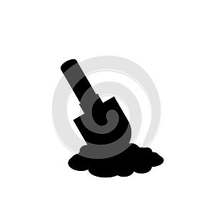 Black silhouette of shovel icon in the soil on white background.