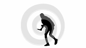 Black silhouette of thief on isolated white background. A male robber in a hoodie and balaclava walks with a knife in