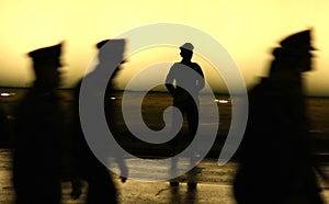 Black silhouette on wall background of a uniformed police officer photo