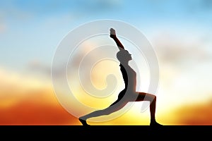 Black silhouette of woman doing yoga exercise.