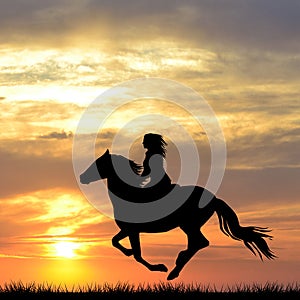 Black silhouette of woman riding a horse at sunrise