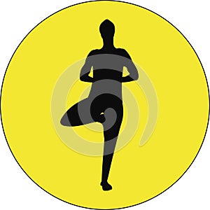 Black silhouette of a young man standing in Tree asana yoga pose on a bright yellow circle back