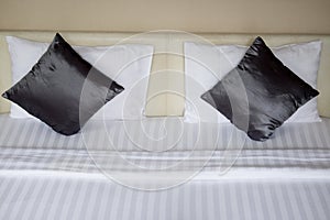 Black silk pillow on bed
