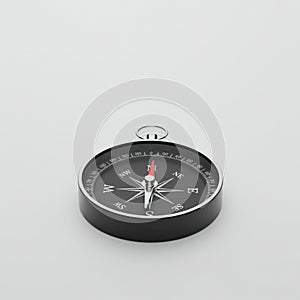 Black and silver compass with a circular design on a light gray background. The