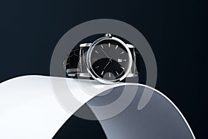 Black and silver high end watch on a dark background