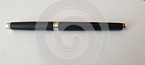 Black silver pen on white table
