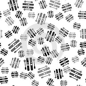 Black Ski and sticks icon isolated seamless pattern on white background. Extreme sport. Skiing equipment. Winter sports