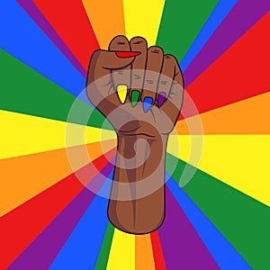 Black skinned female pride fist with lgbt rainbow colored finger nails and rainbow rays in background. Sign for gender equality