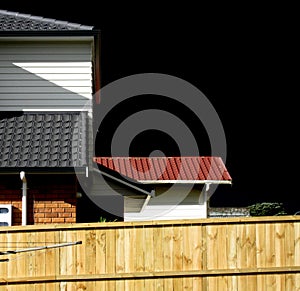 Black sky over tiled roof houses photo
