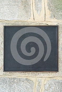 Black Slate Plaque on a Stone Wall