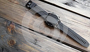 Black smart watch Huawei WATCH GT2 on a wooden table. Black watch on hand. Modern technologies. photo