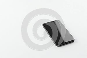 Black smartphone on a white background. Space for text. photo