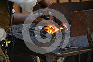 Black smith heating up an iron