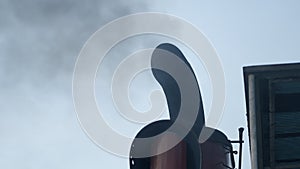 Black Smoke From Ferry Boat Flue Against Clear Sky At Daytime. close up