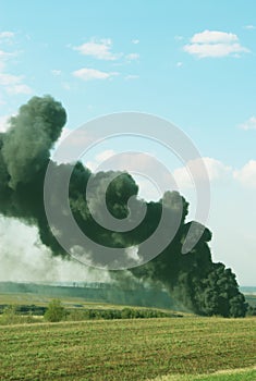 Black smoke rises, smoking and polluting - vertical photo