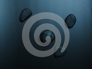 Black smooth snones on dark background.