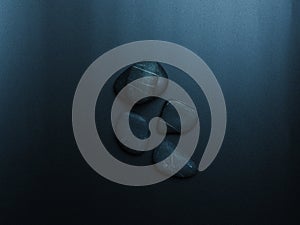 Black smooth snones on dark background.