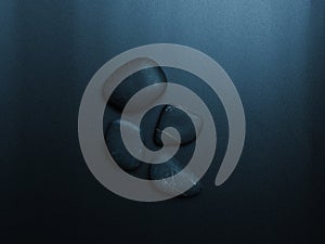 Black smooth snones on dark background.