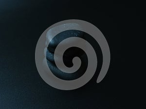 Black smooth snones on dark background.