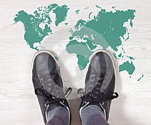 Black Sneakers on a World Map Outline