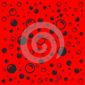 Black soap bubbles on a light red background