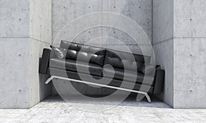 Black sofa wedged between two concrete walls photo