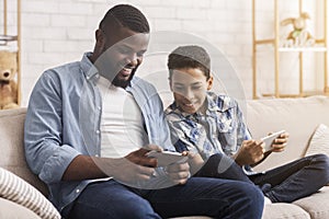 Black Son Competing In Video Games On Smartphones With His Dad