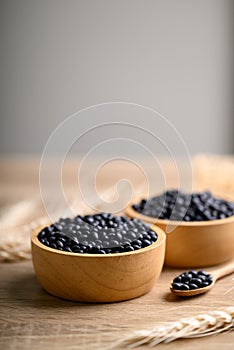 Black soybean seeds in bowl with spoon
