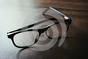 Black Spectacle on wooden table