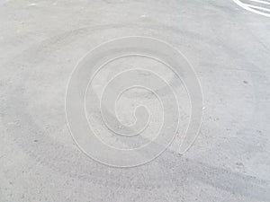 Black spiral skidmark on black asphalt or pavement