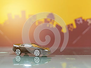 Black Sport racer car toy selective focus on blur city background