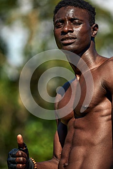 Black sportsman shows a dummy up during workout, outdoor exercise, African Americans train on the sports ground, in an