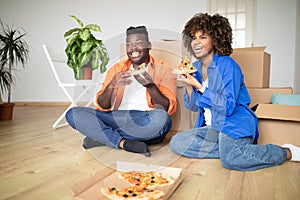 Black Spouses Eating Pizza And Watching Tv After Moving To New Home