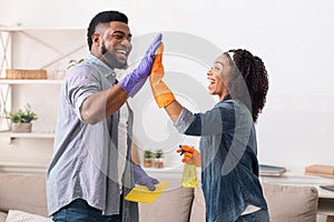 Black Spouses Giving High Five To Each Other After Spring-Cleaning Home