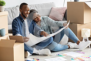 Black Spouses Planning Home Renovation, Checking Blueprints And Color Palette