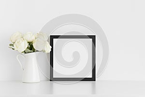 Black square frame mockup with a bouquet of white roses in a vase on a white table