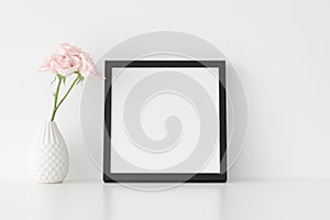 Black square frame mockup with soft pink roses in a vase