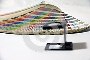 Black square Magnifying glass and Rainbow Sample Colors Palette Catalog.