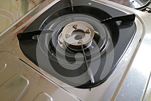 Black square placemats on the gas stove