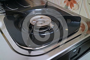 Black square placemats on the gas stove